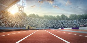 Sunny olympic sport stadium with crowds of people at the background. On behind the stadium are green trees. The image was made in 3d.